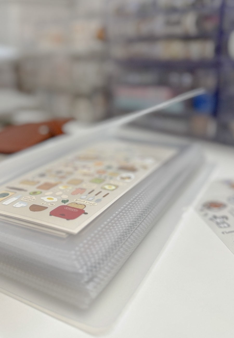 Close-up of a notebook with stickers on a blurred background