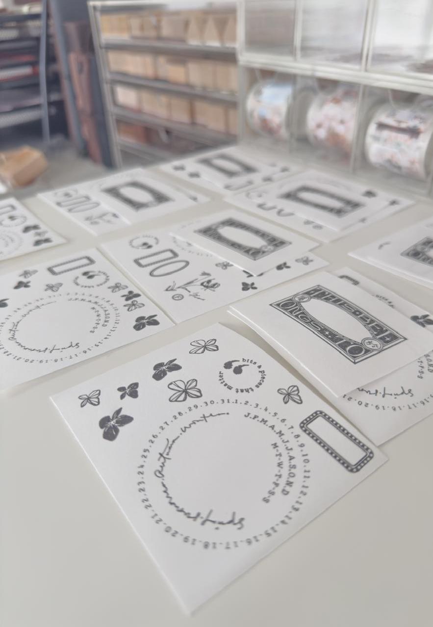Collection of black and white stamps on a table in a workshop setting