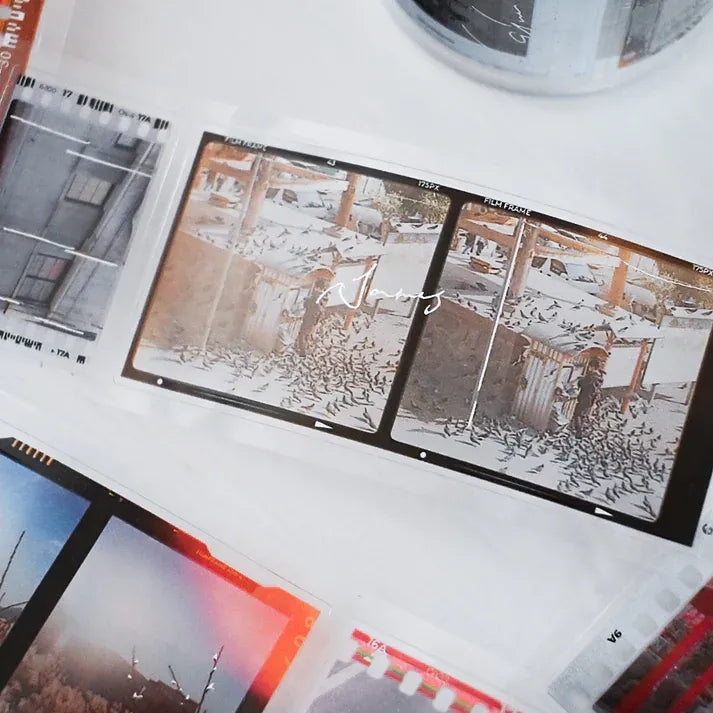 Collage of architectural drawings and photographs on a white surface