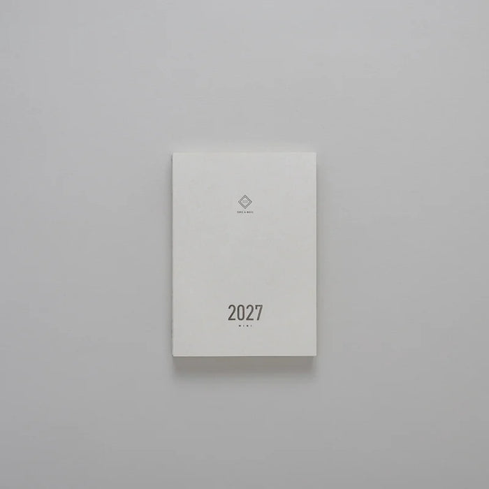 2027 Mini Planner A6 by Take a Note — compact white cover with gold-foil 2027 and logo, for journaling & planning