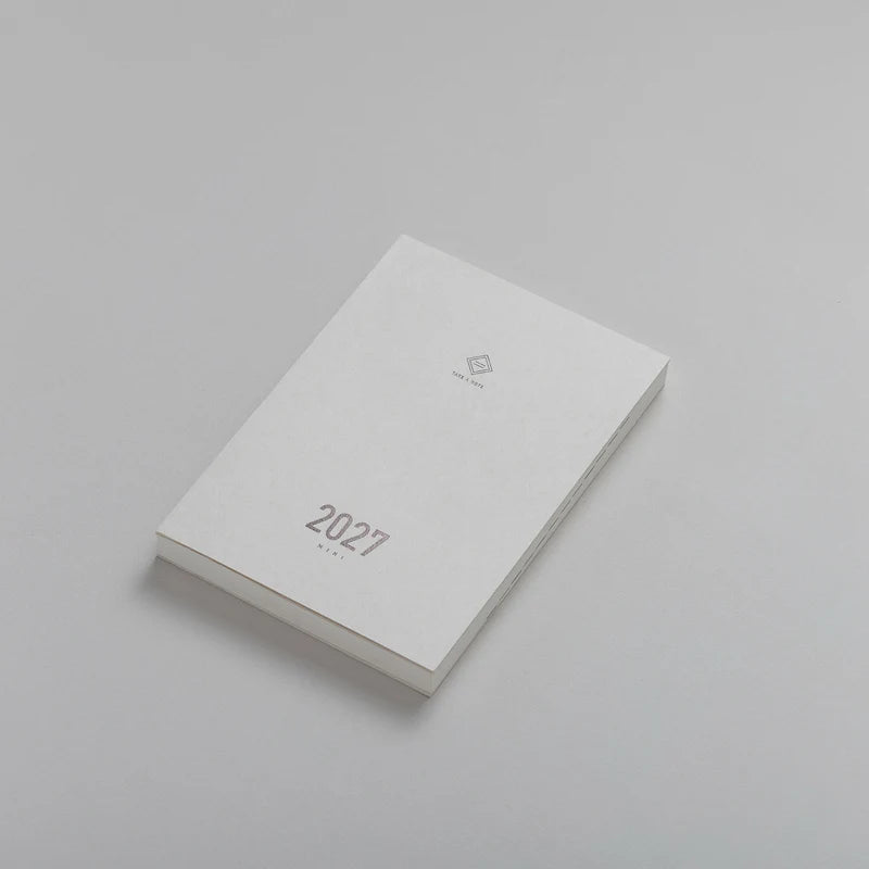 2027 Mini Planner A6 by Take a Note — compact white planner shown at an angle, for planning