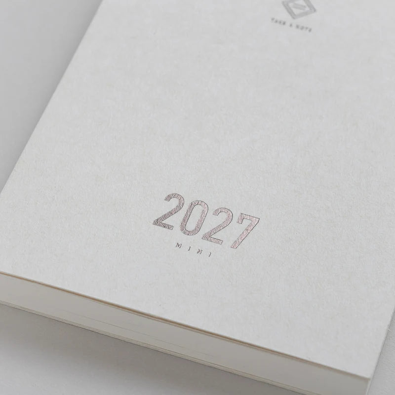 2027 Mini Planner A6 by Take a Note — close-up of the textured white cover with rose-gold foil, for journaling