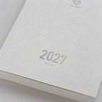2027 Mini Planner A6 by Take a Note — close-up of the textured white cover with rose-gold foil, for journaling