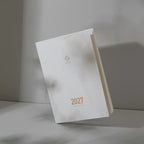 2027 Regular Planner A5 by Take a Note — white planner standing upright with gold-foil cover detail, for planning
