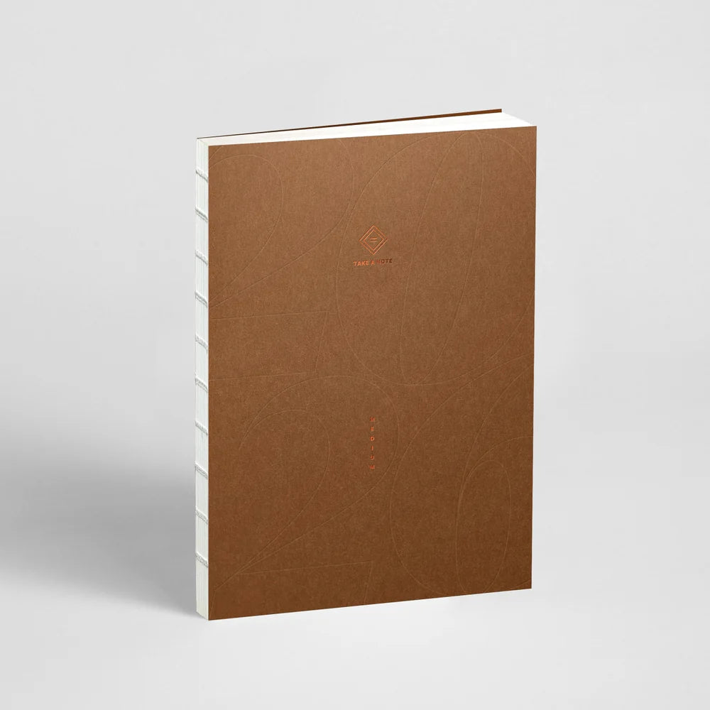 Brown notebook with a visible brand logo on a light gray background
