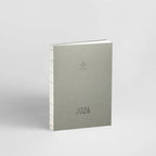 Gray planner with '2026' on a light gray background