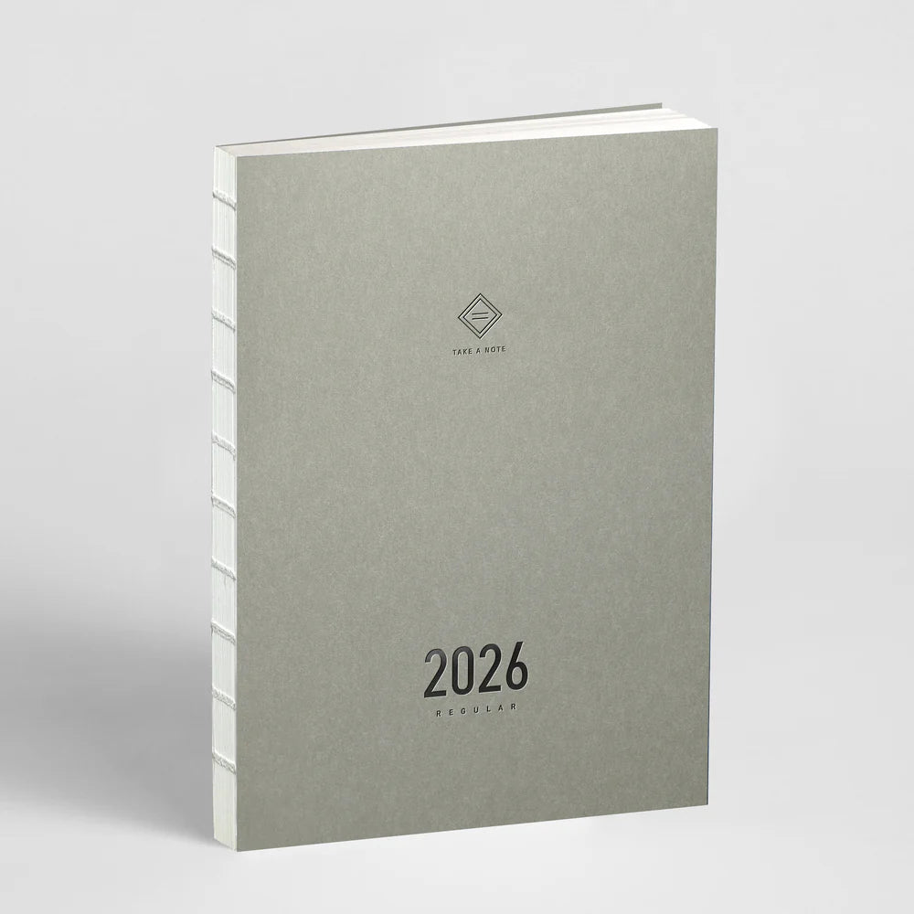Gray planner with '2026' on a light gray background