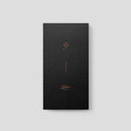 Black slim notebook with gold text on a light gray background