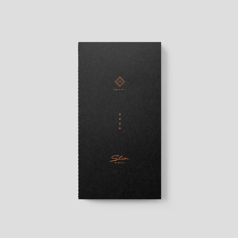 Black slim notebook with gold text on a light gray background