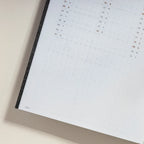 2027 Slim Biweek Planner by Take a Note — grid pages with the black cover, angled view, for journaling