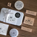 Collection of rubber stamps and stationery items on a wooden surface