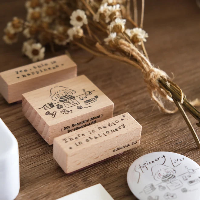 My Beautiful Mess engraved wooden stamps styled with dried flowers on a wooden surface