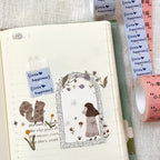 Decorative tape with illustrations and text on a notebook page