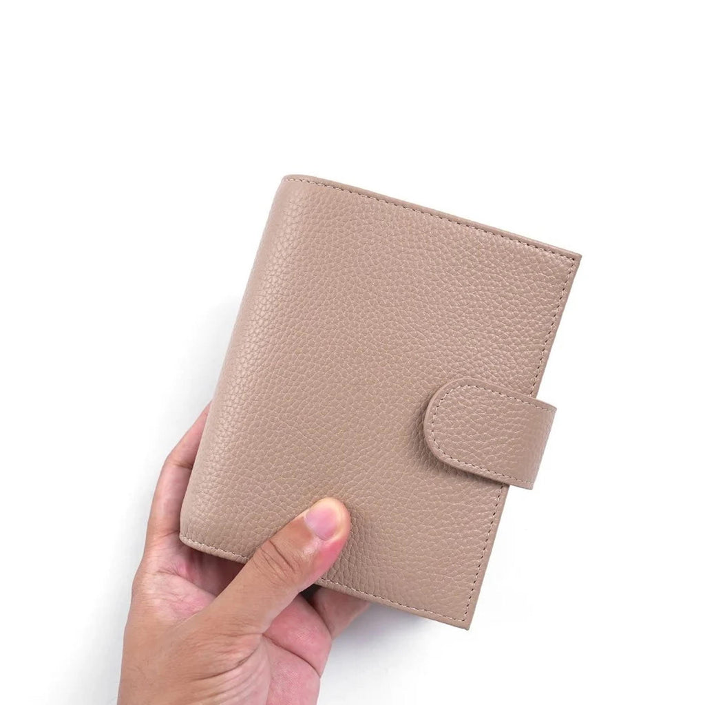 Regular 2.0 Rings Planner Pocket by Moterm — hand holding the taupe pebbled-leather planner, for journaling