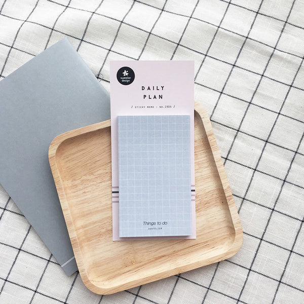 Daily Plan.04 sticky memo pad by Suatelier on a wooden tray, grid background
