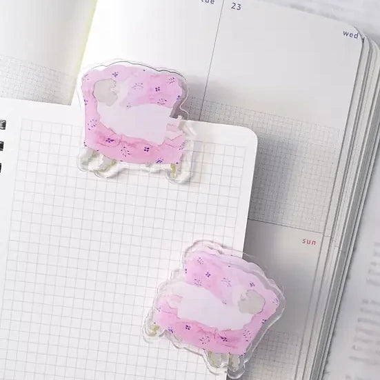 Sofa Journaling Clip by Dodolulu — two pink sheep-shaped acrylic clips on notebooks, for journaling
