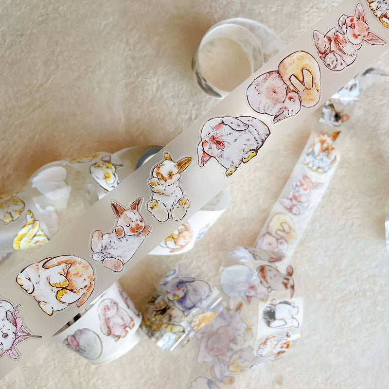Strip of Cute Rabbit Ji A34 PET Tape cartoon rabbit designs applied on a textured surface