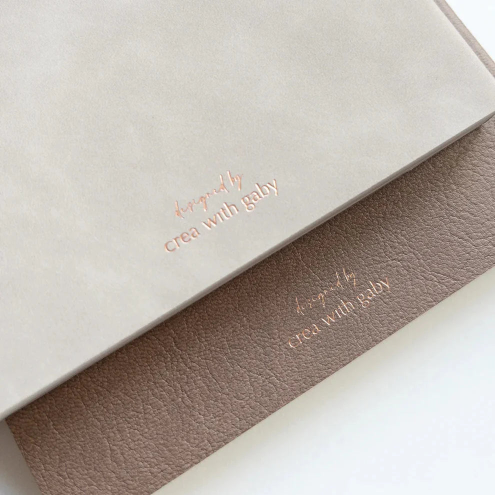 The Memory Keeper journals in beige and taupe with textured covers and gold crea with gaby foil