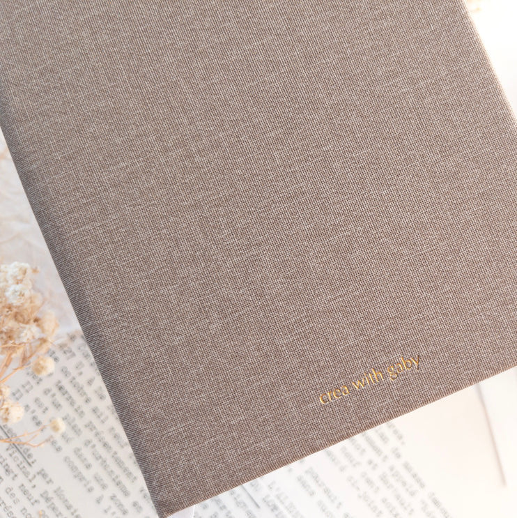 Brown textured A6 Blank Notebook with crea with gaby branding on a light background
