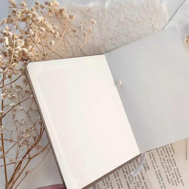 Open A6 Blank Notebook with a blank page, dried flowers and light fabric styling around