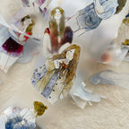 Illustrated paper dolls on a textured surface