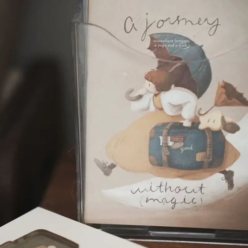 Book cover with a cartoon character holding an umbrella and a suitcase, titled 'A Journey without Magic'.