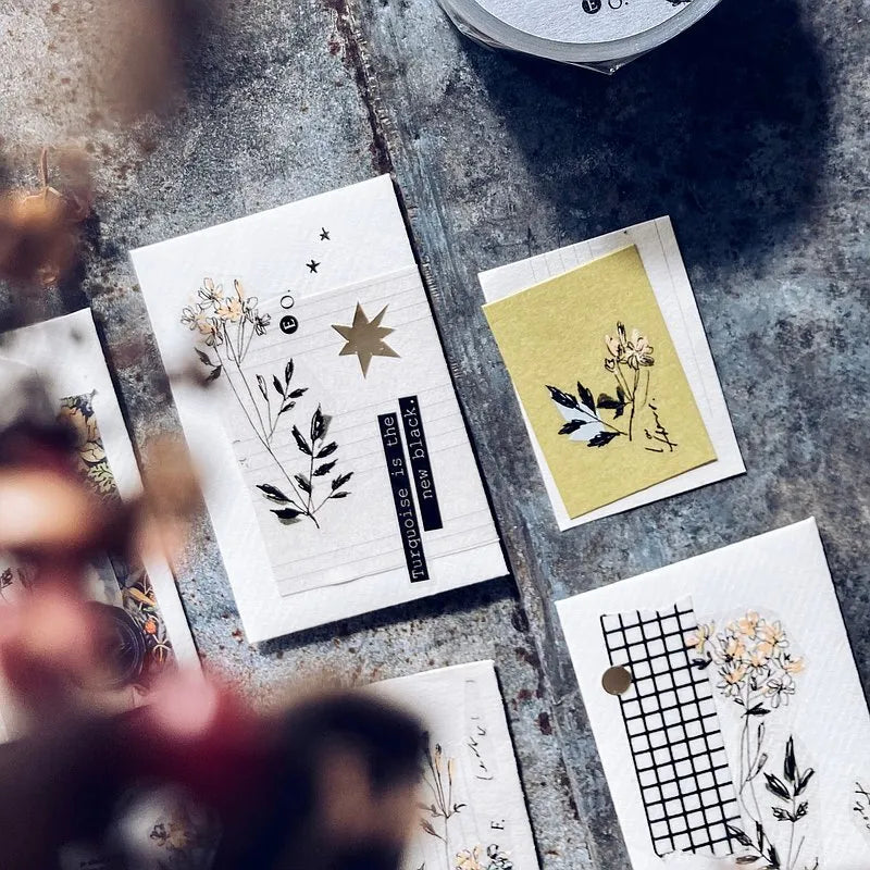 Set of greeting cards with floral and geometric designs on a textured surface