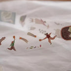 Fabric with baseball-themed illustrations of players and equipment on a white background