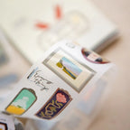 Close-up of a phone case with decorative stickers on a blurred background