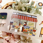 Decorative sticker of a flower shop with plants and flowers in the background