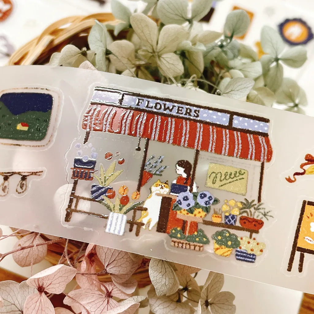 A Moving Day Crystal PET Tape flower shop sticker with plants and blooms in the background