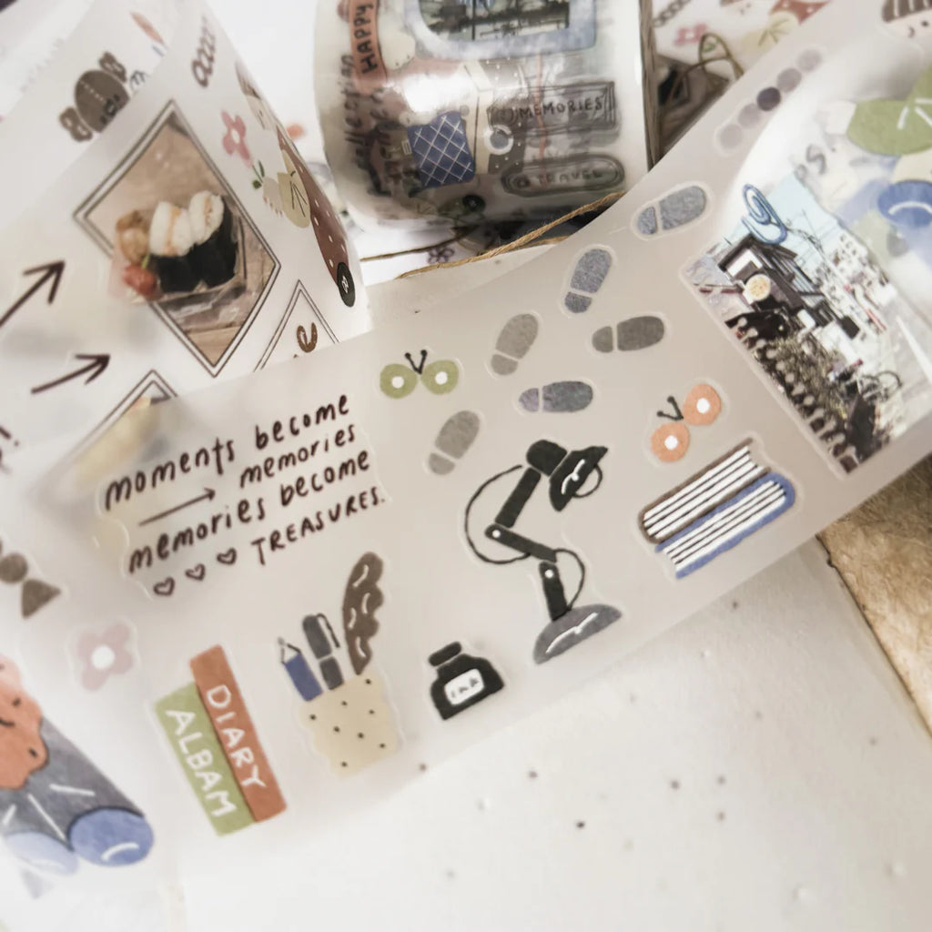 Collection of decorative washi tape rolls with various designs on a white surface.