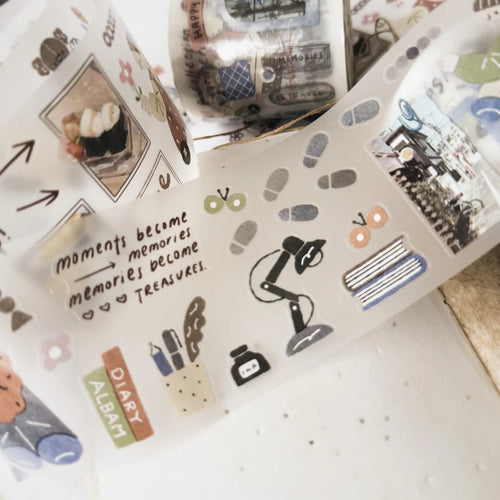 Collection of decorative washi tape rolls with various designs on a white surface.