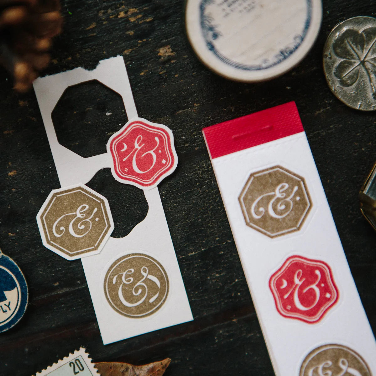 Decorative stickers with monograms on a dark wooden surface