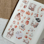 Sheet of autumn-themed stickers with pumpkins, leaves, and people on a textured surface.