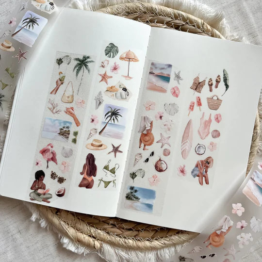 Beach Day PET Tape by ArtStudioLea styled on an open book with seaside sticker designs on a woven surface
