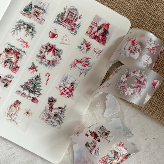 Roll of Christmas Cheer PET Tape partially unrolled to show its holiday motifs on a textured surface