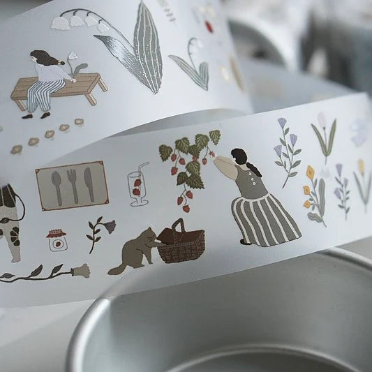 Decorative paper strip with illustrations of a woman, plants, and other elements on a white background.
