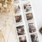 Collection of black and white photos on a textured surface with decorative elements.