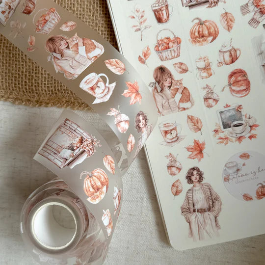 Sticker sheets of Autumn Is Here PET Tape autumn illustrations laid out on a textured surface