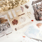 Collection of autumn-themed stationery items on a white surface with blurred natural background