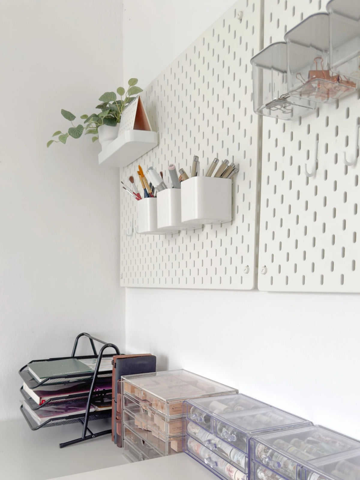 Avyanna Decore studio wall with white pegboard organizer, shelves and stationery storage