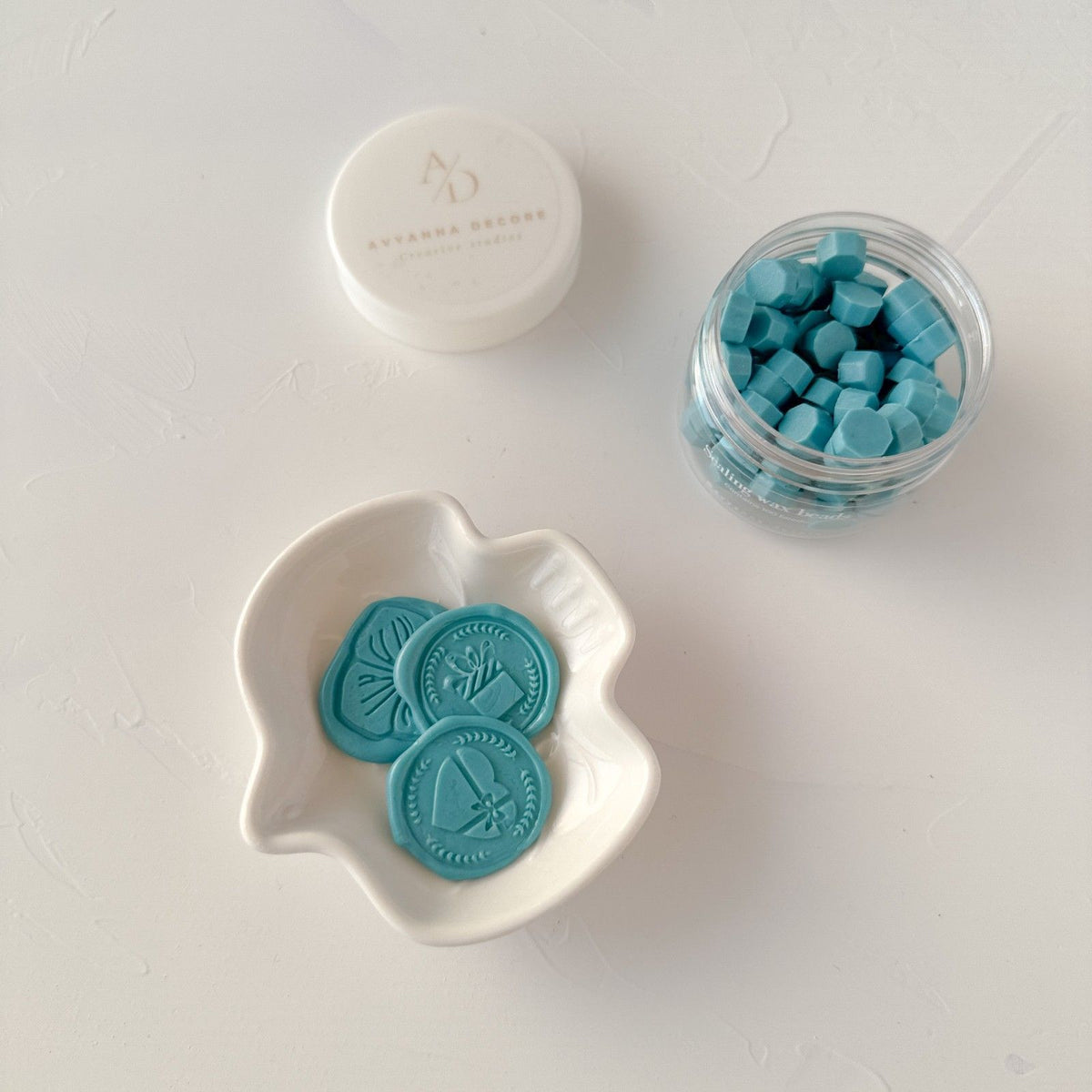 Baby Blue Wax Beads in a soft sky-blue shade filling a white dish and storage jar on a light background
