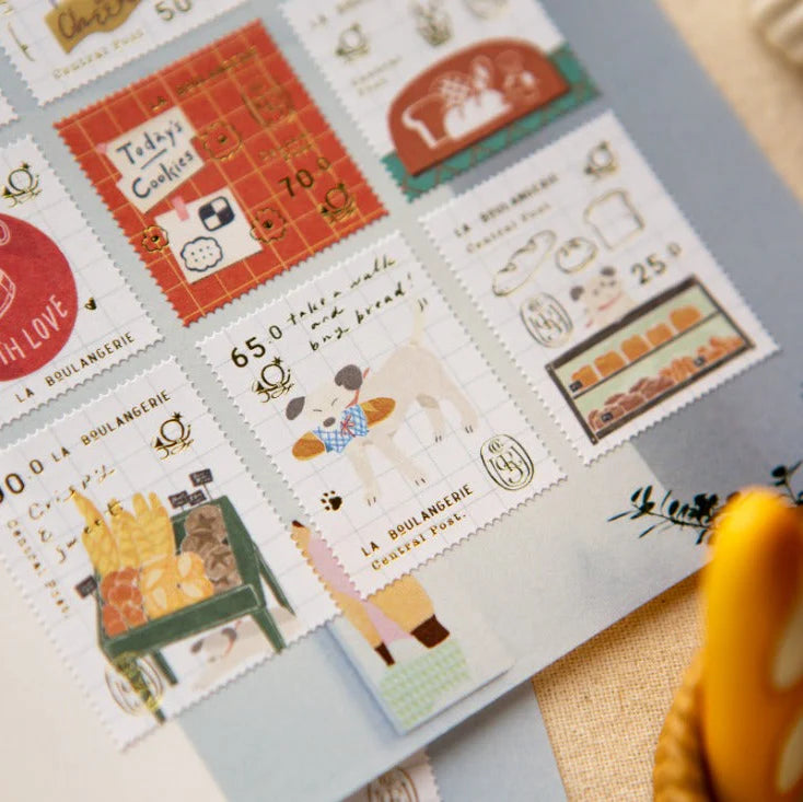 Collection of decorative stamps with illustrations and text on a flat surface.