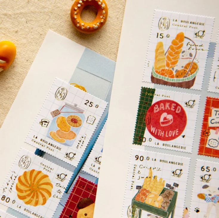 Collection of decorative stamps with food illustrations on a textured surface.