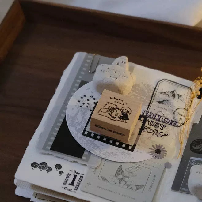 Travel Together Again Rubber Stamp with a cat design on a stack of vintage illustrated cards