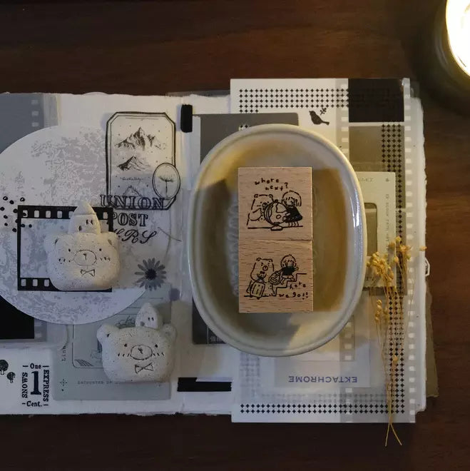 Travel Together Again wooden stamp resting on a white dish surrounded by stationery on wood
