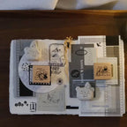 Collection of stamps and decorative items on a wooden surface