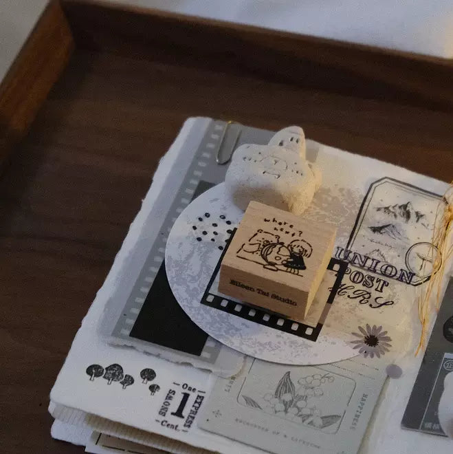 Travel Together Again stamp with a cat design on a stack of books with vintage illustrations