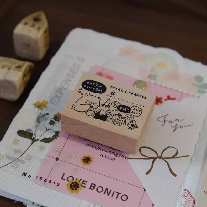 Wooden Buy or Bye Rubber Stamp on a pink Love Bonito card surrounded by stationery items